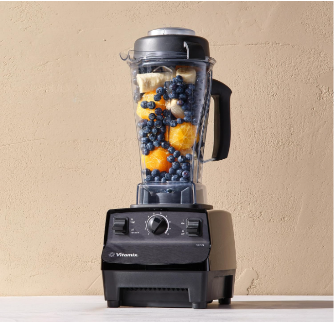 Vitamix blender with fresh blueberries and orange slices